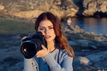 young woman taking photo with digital camera