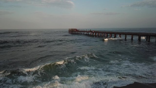 4K aerial drone video of Namibian Atlantic coastline, Swakopmund vintage buildings, town panorama, beach, old Jetty pier, landscape with ocean background of holiday resort at Namibia's west coast