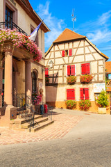ALSACE WINE REGION, FRANCE - SEP 18, 2019: Town hall building and typical house in Beblenheim village which is located on Alsatian Wine Route, France.