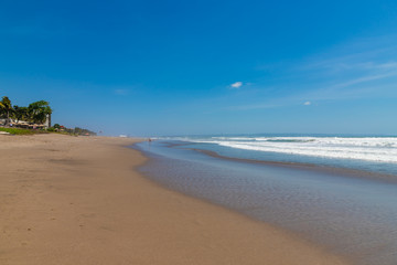 Seminyak beach. Wide sand beach with big waves, good for surfing; Bali island, Indonesia