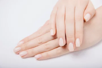  Stylish trendy nail young woman hands pink manicure on white background © Parilov