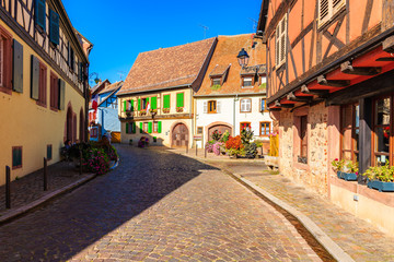 KINTZHEIM VILLAGE, FRANCE - SEP 19, 2019: Colorful houses decorated with flowers on street in beautiful old village of Kintzheim which is located on famous Alsace wine route, France.