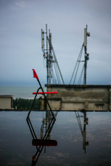 a red chair and its reflection on the roof