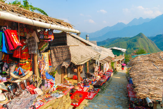 Street in Cat Cat Hmong village by Sapa with market full of traditional colorful clothes, Vietnam 