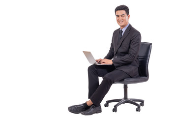 Young business man sitting in office chair with confident smiling and working on laptop isolated on white background, copy space and business concept.