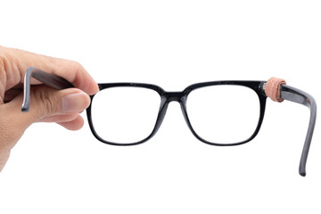 Hand holding Broken eyeglasses first-person view isolated on white background.