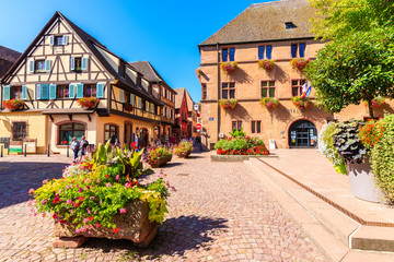 Fototapeta na wymiar ALSACE WINE REGION, FRANCE - SEP 20, 2019: Square with typical houses in Kaysersberg picturesque village which is located on Alsatian Wine Route, France.
