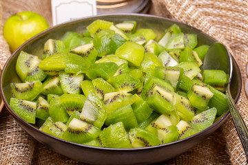 Kiwi pieces peeled in a plate for breakfast