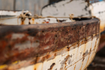 Decrepit old row boats in the harbor in Naples, Italy during the morning following a rain storm.