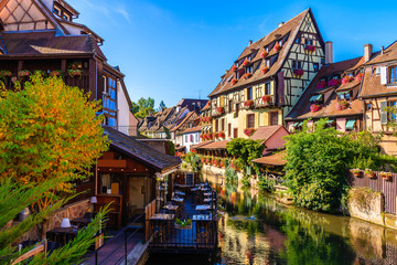 Restaurant terrace with tables located on canal bank in Colmar village, Little Venice, Alsace Wine Route, France
