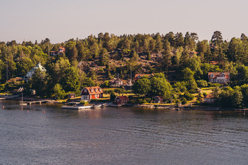 Small cottages in the Stockholm archipelago with piers for their small boats, Sweden
