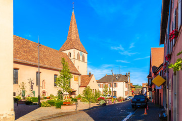 Beautiful church and traditional colorful houses in picturesque Kientzheim village, Alsace wine region, France