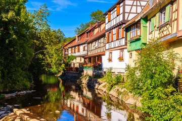 Beautiful traditional colorful houses on canal bank in picturesque Kaysersberg village, Alsace wine region, France