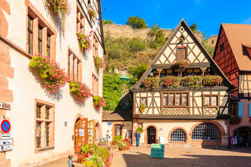 Fototapeta na wymiar ALSACE WINE REGION, FRANCE - SEP 20, 2019: Colorful houses decorated with flowers in Kaysersberg village which is located on Alsatian Wine Route, France.
