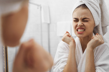 woman applying cream on her face