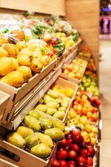 Wooden fruit counter in a supermarket. Vitamins and health. Blurred. Vertical.
