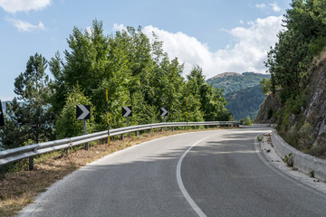 road bending among hilly woods, near Paterno, Italy