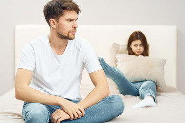 Fototapeta premium young couple sitting on sofa watching tv