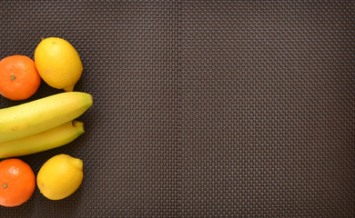 Fototapeta na wymiar Seasonal fruits and berries: banana and citrus