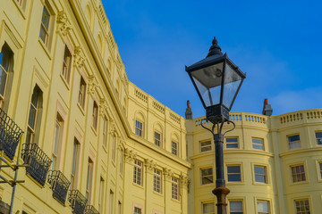 Fototapeta na wymiar Hove, UK, 29/12/2019: Street lamp against the background of a yellow Victorian style building