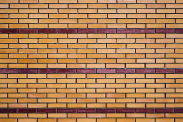 Beschaffenheit einer gelben Ziegelsteinwand mit roten Linien als abstrakter Hintergrund