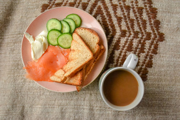 Simple breakfast, top view: fried eggs, toast, cheese, cherry tomatoes