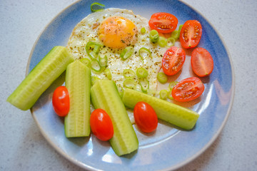 Eggs, tomato and cucumber breakfast 