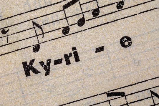 the word Kyrie on a page of an old prayer and hymn book