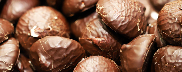Selective focus. Marshmallows in chocolate as a background.