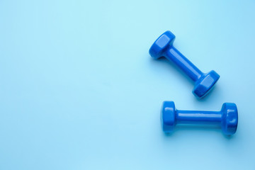 New dumbbells on color background