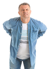 Mature man suffering from back pain on white background