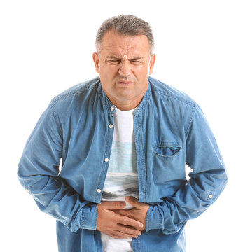 Mature man suffering from abdominal pain on white background
