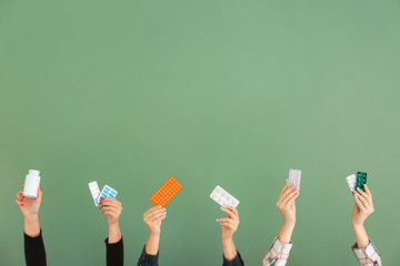 Female hands with different medicines on color background