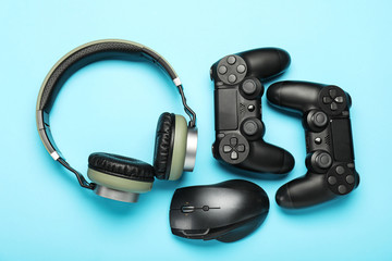 Modern gaming accessories on color background