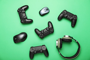 Modern gaming accessories on color background