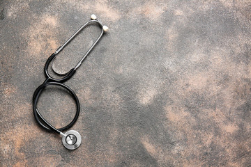 Modern stethoscope on grunge background