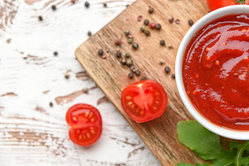 Bowl with tasty barbecue sauce on table