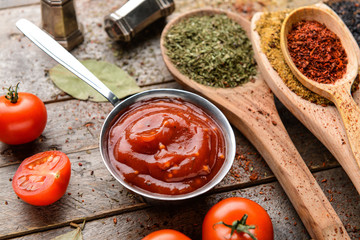 Tasty barbecue sauce and spices on table