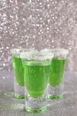 Three glasses with green drinks