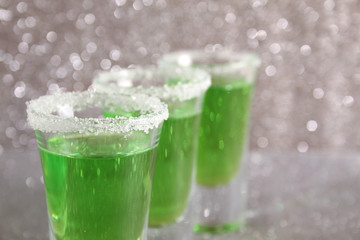 Three glasses with green drinks