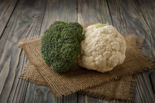  Fresh cauliflower and broccoli on wooden table
