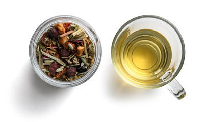 Green tea with natural aromatic additives and a Cup of tea. Top view on white background