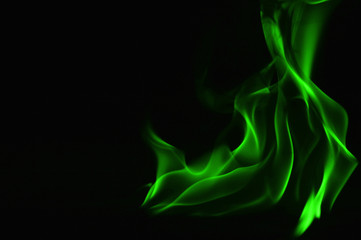 Beautiful fire green flames on a black background.