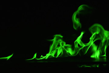 Beautiful fire green flames on a black background.