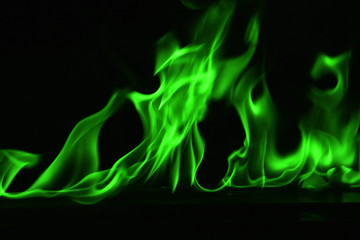 Beautiful fire green flames on a black background.