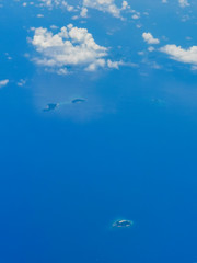 Flying In An Aeroplane Over The Philippine Islands Looking At The Wing, Clouds, Manila And The Blue Ocean