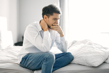 young man sitting on sofa at home