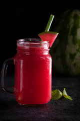 Watermelon drink in a jar with a pen. Cool drink.