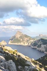 Fototapeta na wymiar Beautiful view from Mirador Es Colomer in Cap de Formentor, Mallorca, Spain. Cliffs in the Mediterranean on a vertical picture. Rocks by the sea. Spanish tourist attraction and popular viewpoint