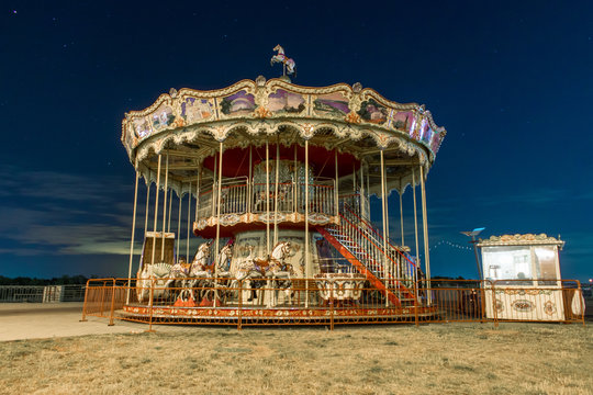 Carousel against the night sky. Vintage carousel with horses at night